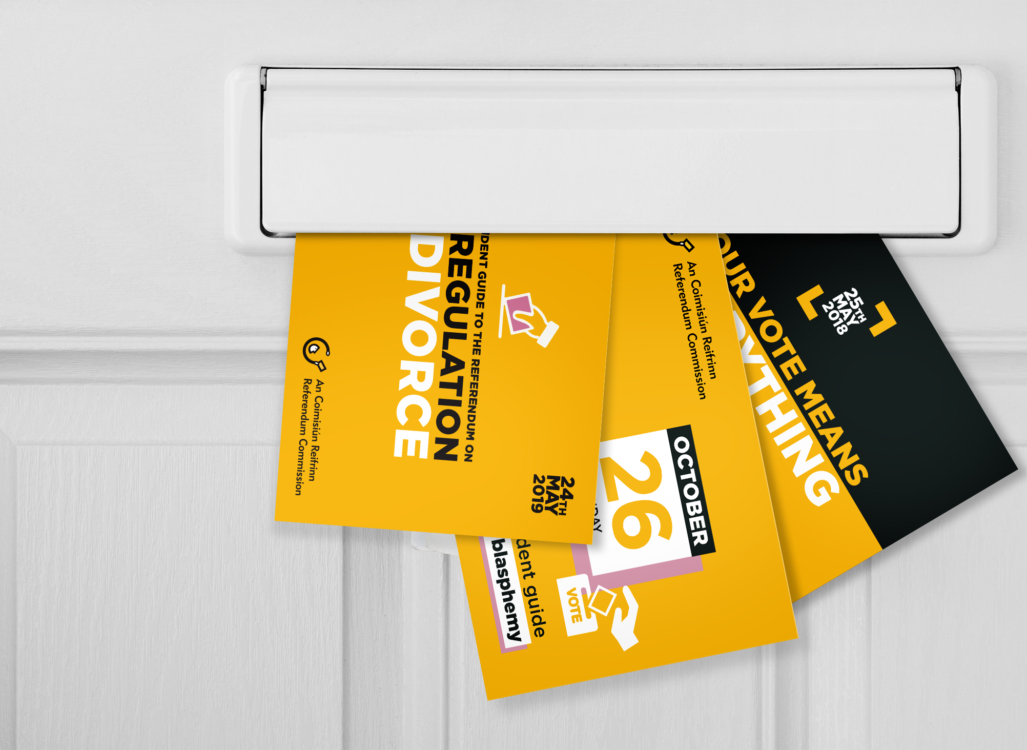 Three guidebooks being placed through a letterbox